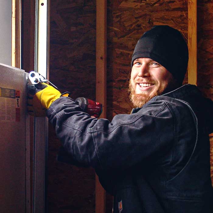 Garage Door Repair Technician Fixing Panel