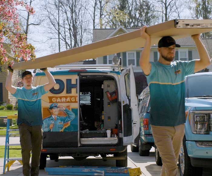 Garage door technicians installing a replacement overhead garage door near Euclid, Ohio