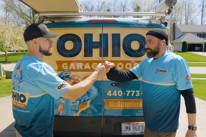 OHGDR Garage Door Repair technicians fist bumping after a completed garage door repair service Chagrin Falls, OH