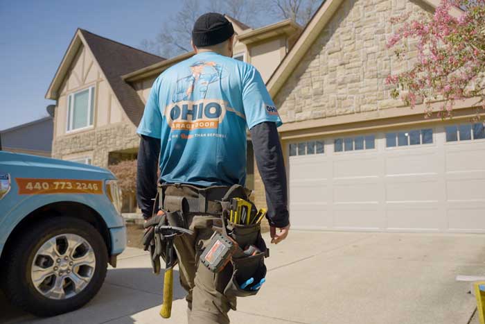 OHGDR Garage Door Repair technician fixing garage door spring near Elyria, OH